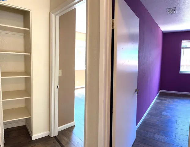 a view of a hallway with wooden floor