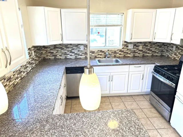 a bathroom with a sink a mirror and a window