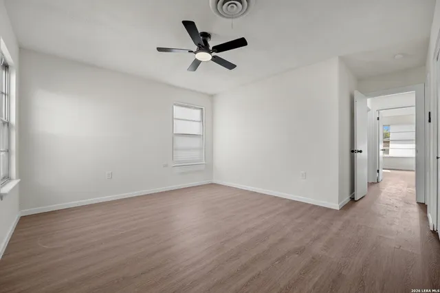 a view of a livingroom with a hardwood floor and a ceiling fan