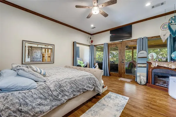 a bedroom with a large bed and a chandelier