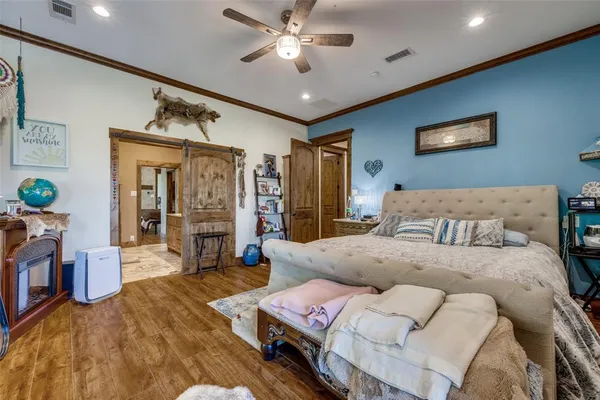 a spacious bedroom with a bed and a ceiling fan
