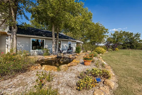 a view of a house with backyard and sitting area