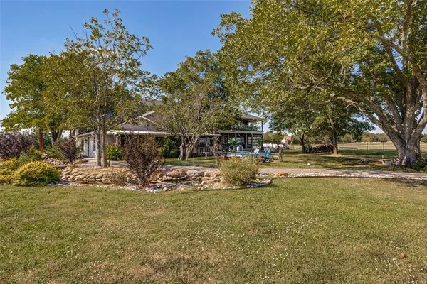 a view of yard with swimming pool and sitting area