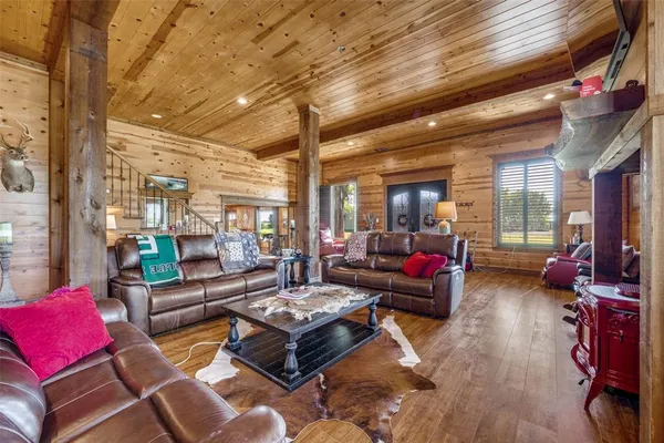 a living room with furniture and a floor to ceiling window