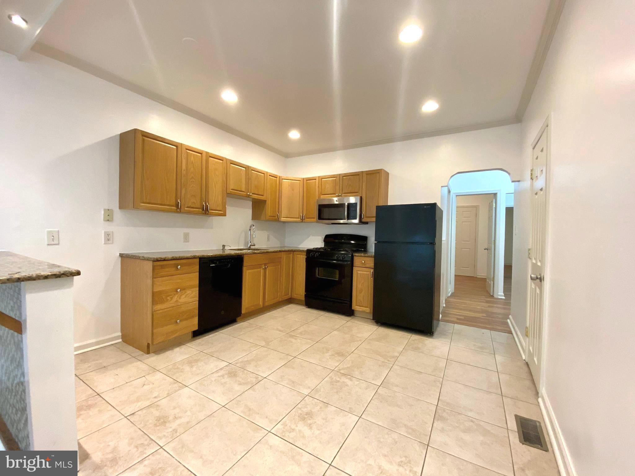 3856 Terrace Street Philadelphia, PA 19128 - Photo 15 of 27 a kitchen with stainless steel appliances granite countertop a refrigerator and a sink