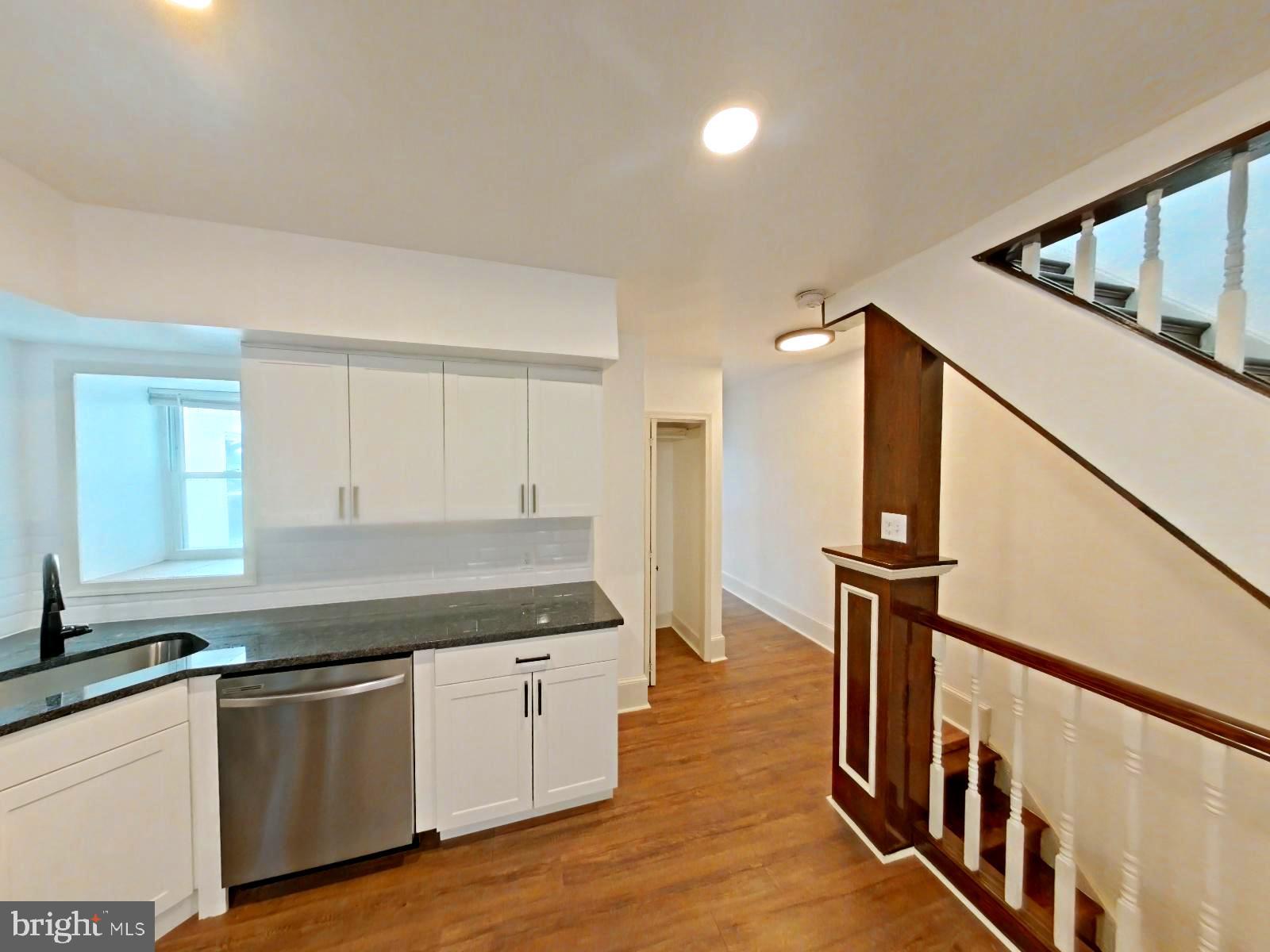 3856 Terrace Street Philadelphia, PA 19128 - Photo 2 of 27 a kitchen with granite countertop a refrigerator a sink and dishwasher a stove with wooden floor