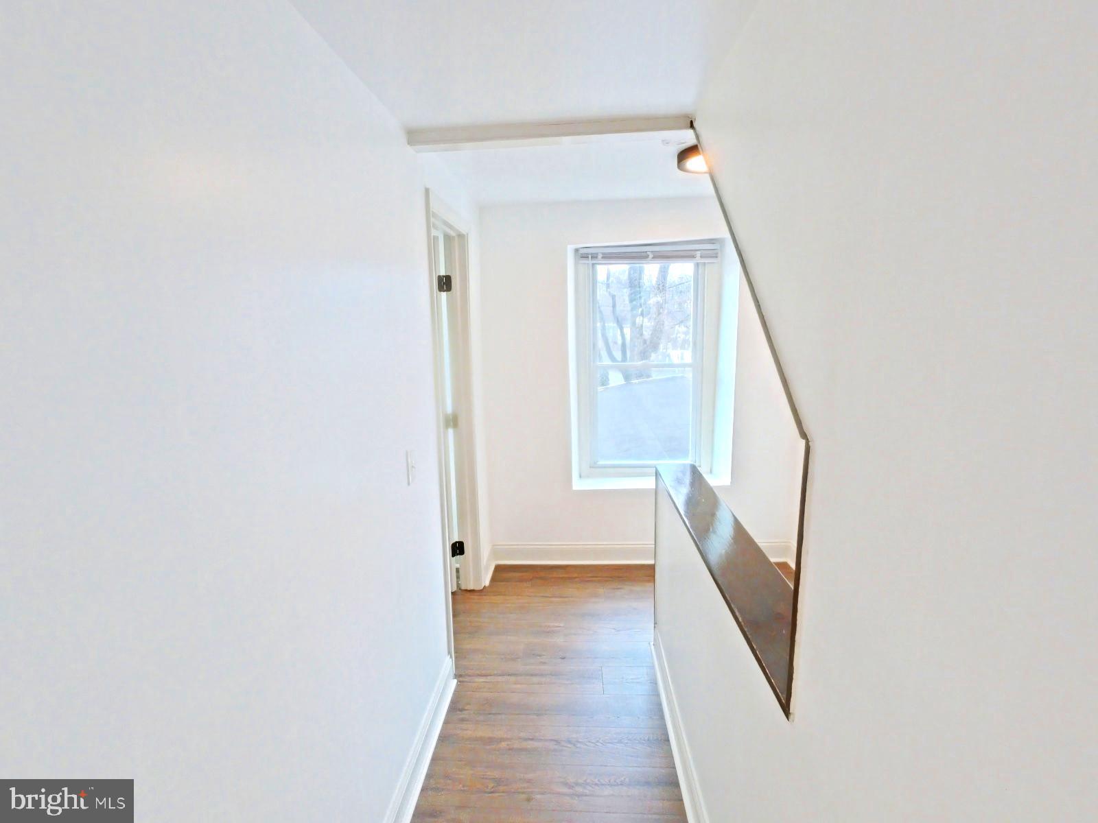 3856 Terrace Street Philadelphia, PA 19128 - Photo 7 of 27 a view of a hallway with wooden floor and staircase