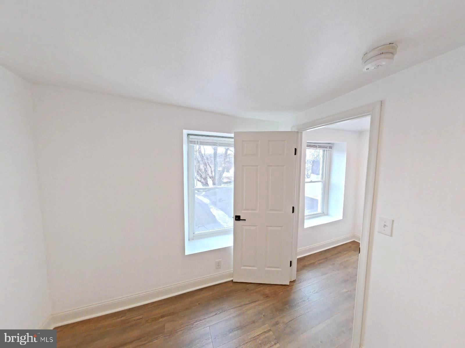 3856 Terrace Street Philadelphia, PA 19128 - Photo 10 of 27 an empty room with wooden floor and windows