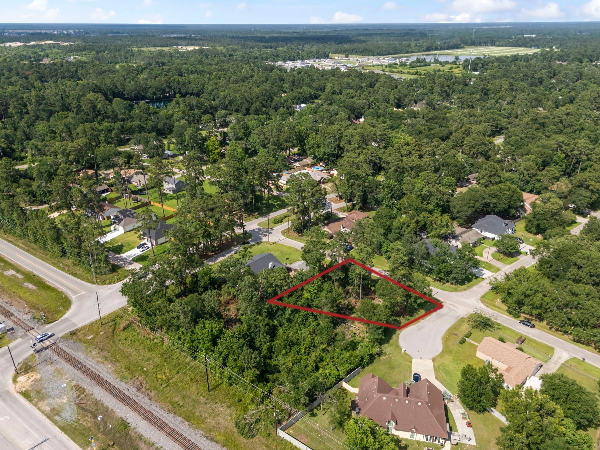 0 Tallow Drive Conroe, TX 77385 - Photo 6 of 11 a view of a forest with a houses