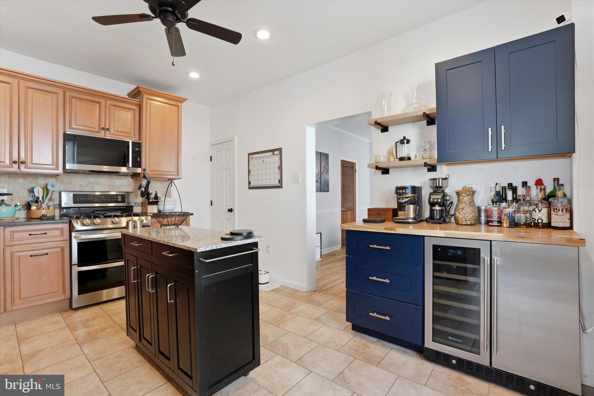 425 Righter Street Philadelphia, PA 19128 - Photo 11 of 35 a kitchen with stainless steel appliances granite countertop a stove top oven a sink dishwasher and a refrigerator with cabinets