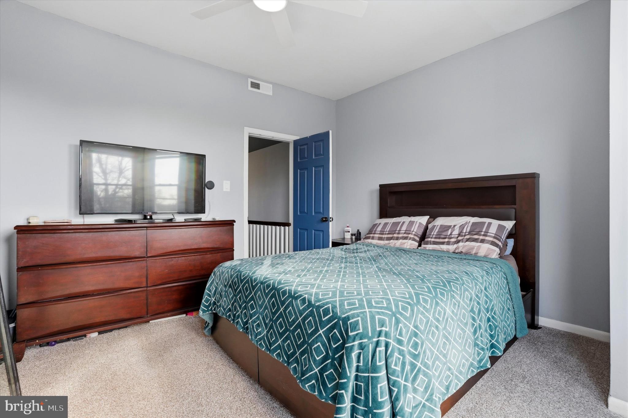 425 Righter Street Philadelphia, PA 19128 - Photo 21 of 35 a bedroom with a bed and a flat screen tv
