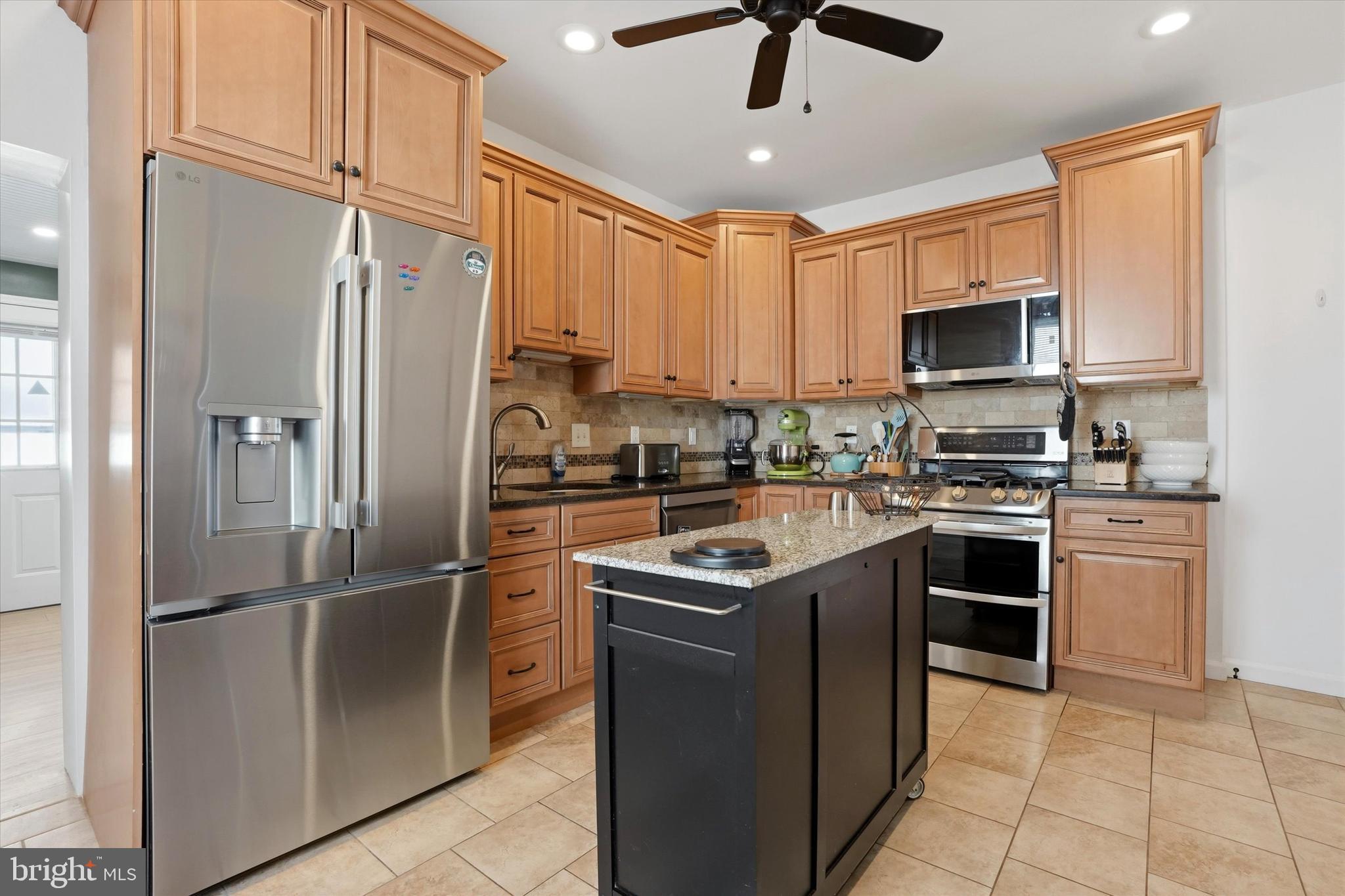 425 Righter Street Philadelphia, PA 19128 - Photo 9 of 35 a kitchen with stainless steel appliances granite countertop a refrigerator a stove a sink and a microwave