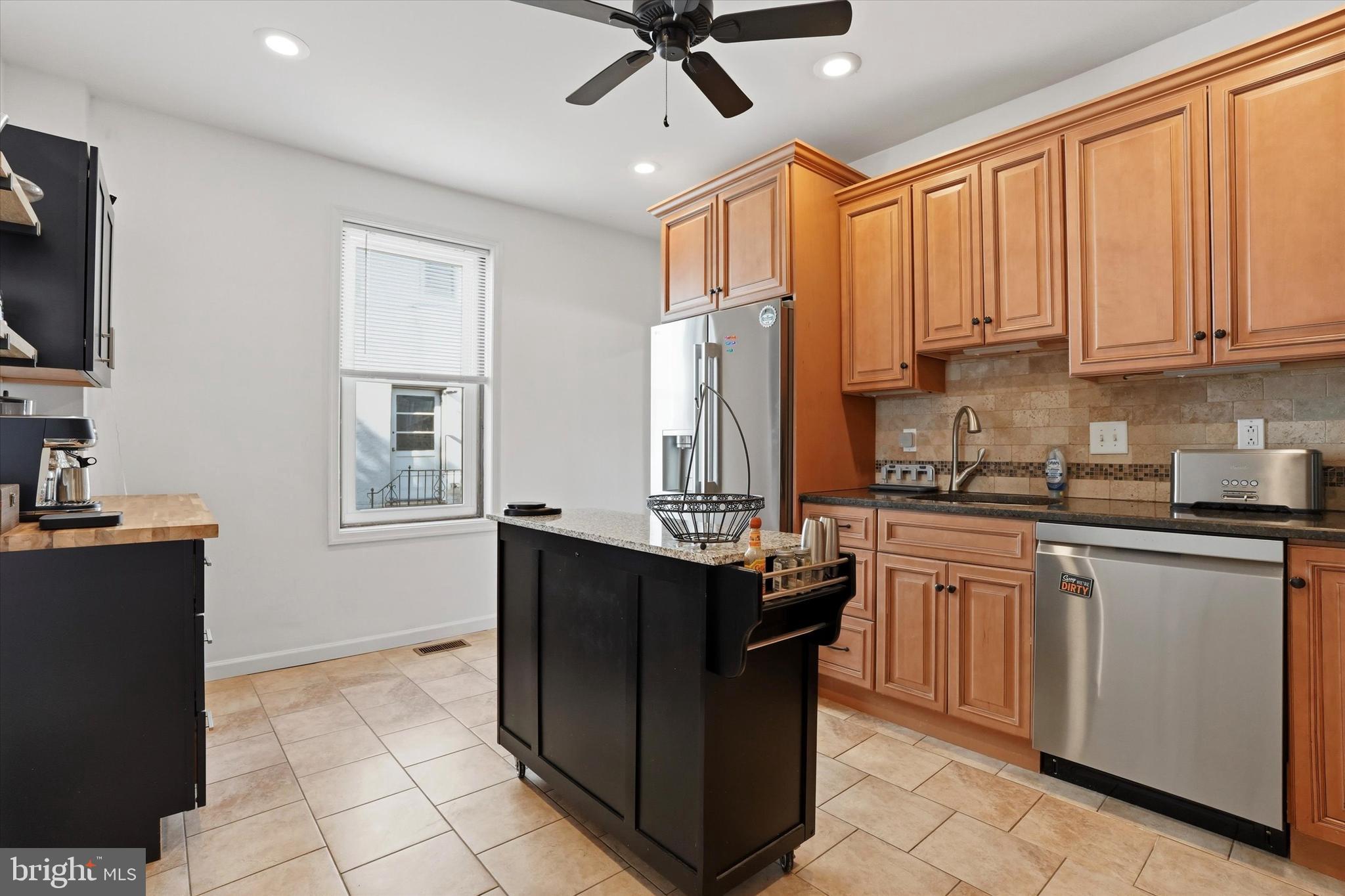425 Righter Street Philadelphia, PA 19128 - Photo 10 of 35 a kitchen with stainless steel appliances granite countertop a stove a sink and a refrigerator