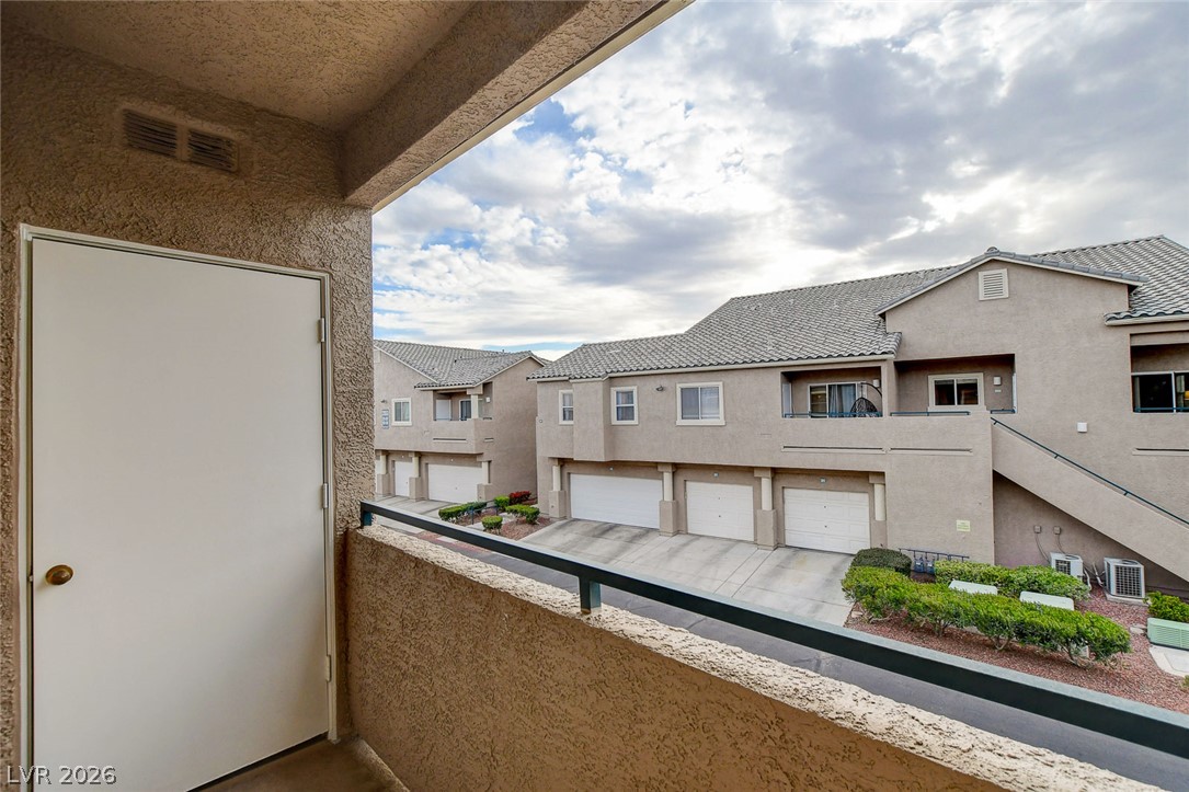 2052 Quarry Ridge Street, Unit 201 Las Vegas, NV 89117 - Photo 23 of 25 A private balcony overlooks the well-maintained community parking and residential structures.