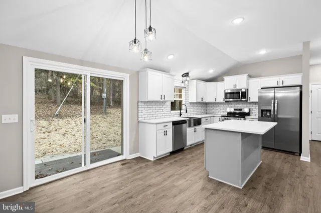 a kitchen with a sink a microwave a stove and refrigerator