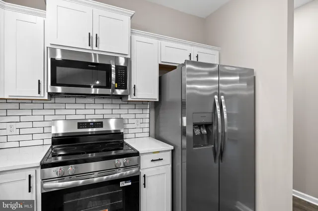 a kitchen with stainless steel appliances granite countertop a sink and cabinets