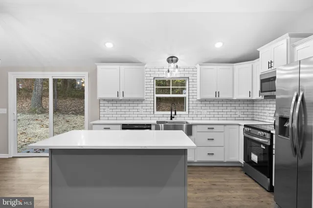 a view of hallway with wooden floor and chandelier