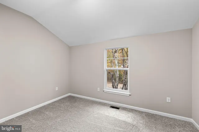 an empty room with closet area