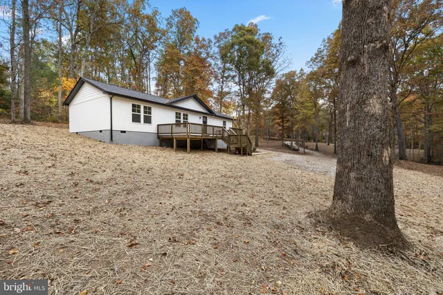 a white house that has a tree in front of it