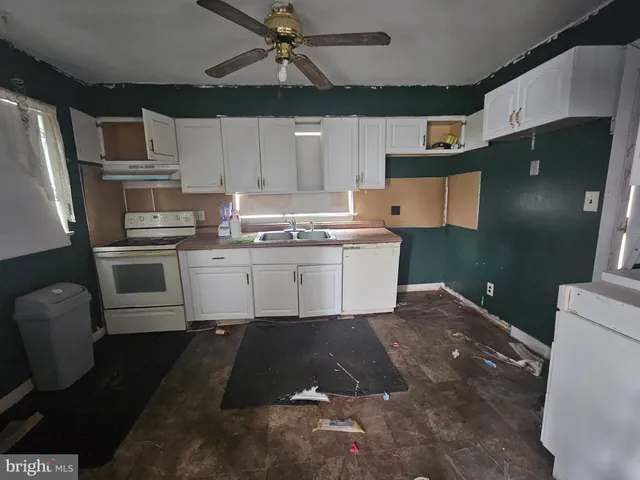 a kitchen with a sink stainless steel appliances and cabinets