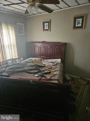 a bed sitting in a bedroom next to a window