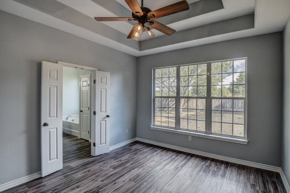 340 Rose Mayer Loop La Grange, TX 78945 - Photo 13 of 30 a view of an empty room with a window and wooden floor