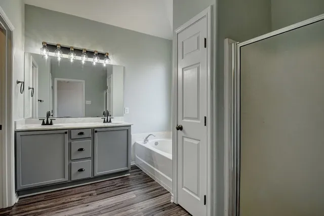 a spacious bathroom with a double vanity sink and a mirror
