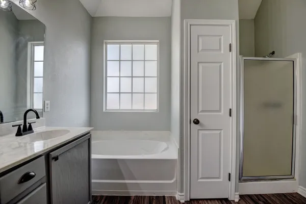 a bathroom with a bathtub and a sink