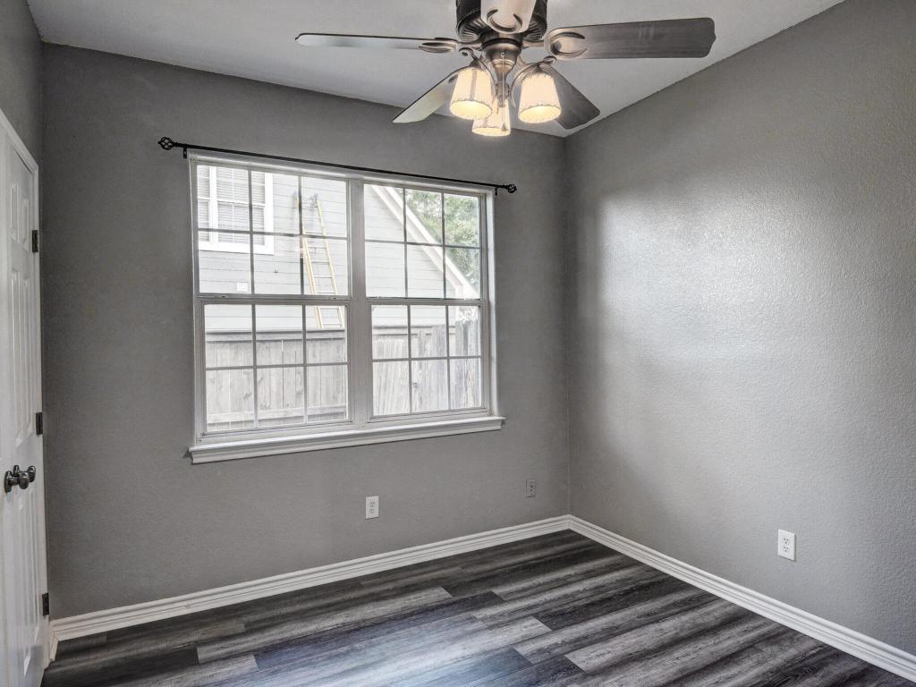 340 Rose Mayer Loop La Grange, TX 78945 - Photo 20 of 30 an empty room with wooden floor fan and windows