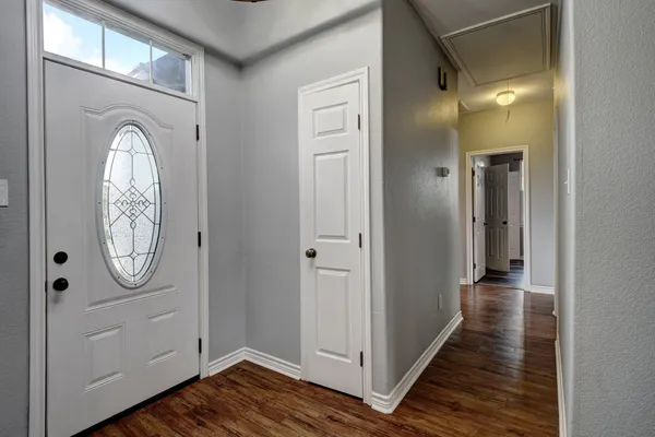 a view of a hallway with wooden floor