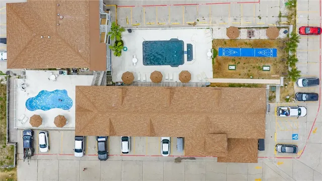 a view of a backyard with swimming pool and seating