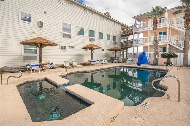 a view of a dry yard with wooden fence