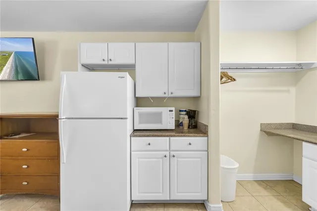a white refrigerator freezer sitting in a kitchen