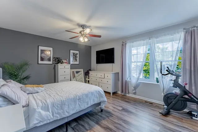 a bedroom with a bed window and a flat screen tv