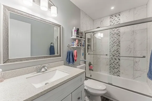 a bathroom with a sink toilet and shower