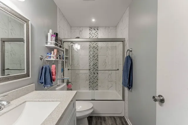 a bathroom with a shower a toilet and a sink