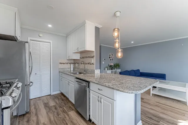 a kitchen with a sink appliances and cabinets