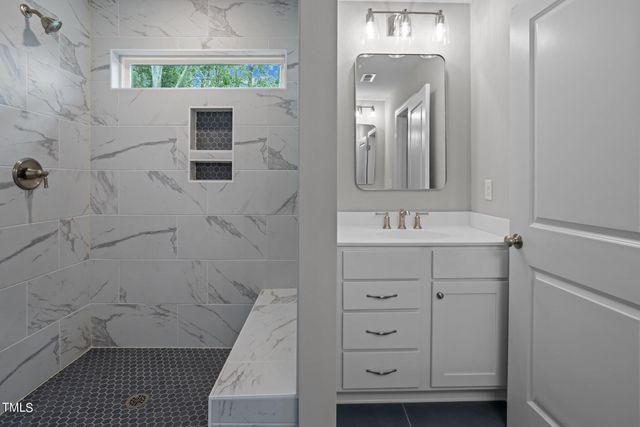 a bathroom with a sink a vanity and a mirror
