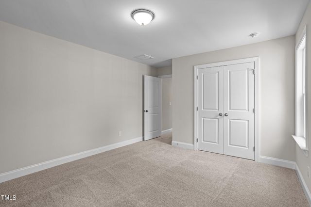 a view of an empty room and closet area