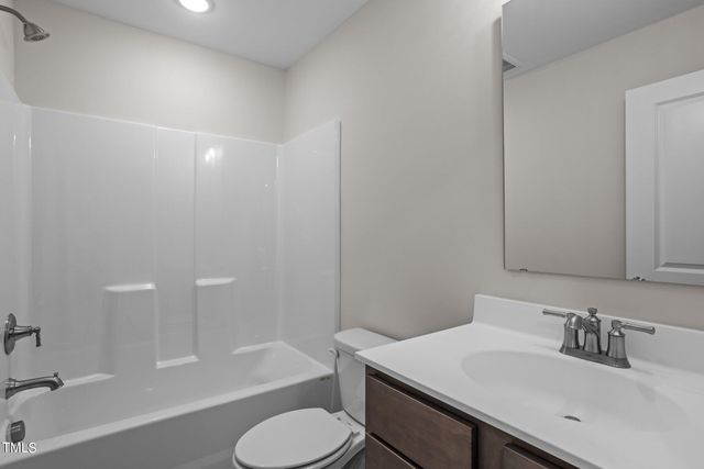 a bathroom with a sink toilet bathtub and vanity