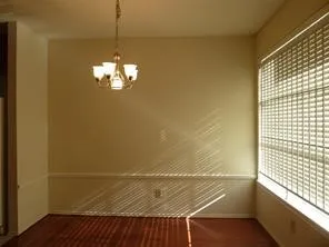 a view of a room with wooden floor and a window