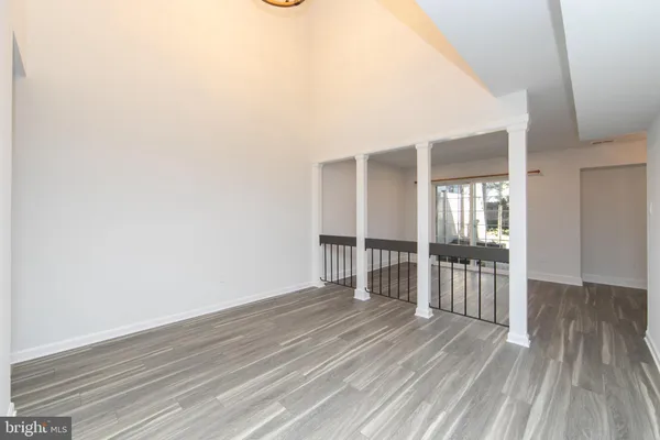 a view of wooden floor and windows in a room