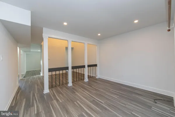 a view of a room with wooden floor