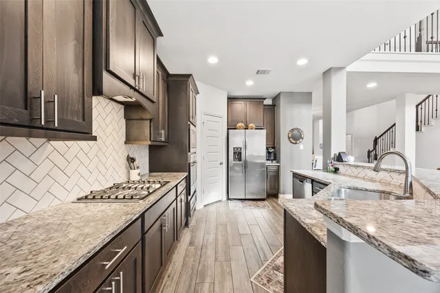 a kitchen with a sink stove and refrigerator