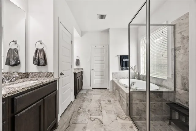 a bathroom with a double vanity sink and mirror