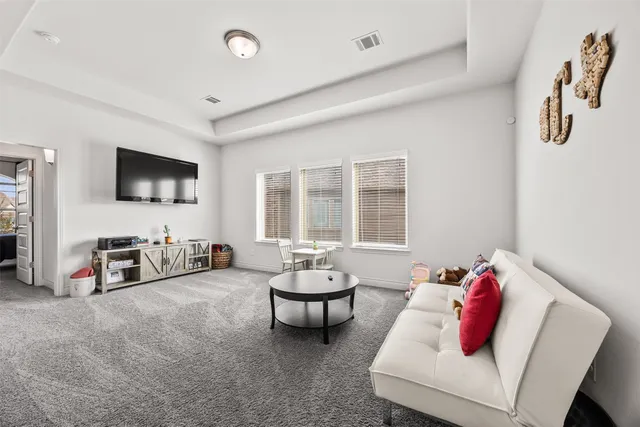 a living room with fireplace furniture and a flat screen tv