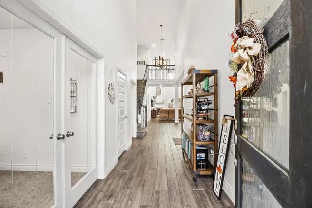 a view of a hallway with wooden floor and staircase