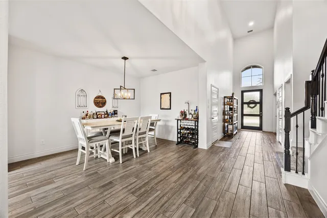 a dining room with furniture entryway and wooden floor