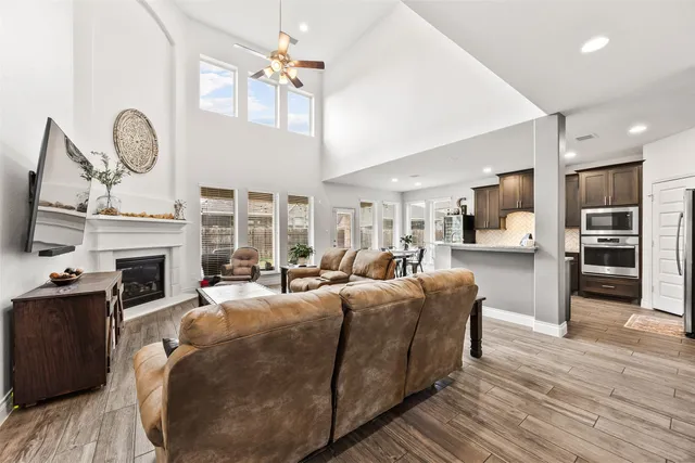 a living room with furniture a fireplace and a flat screen tv