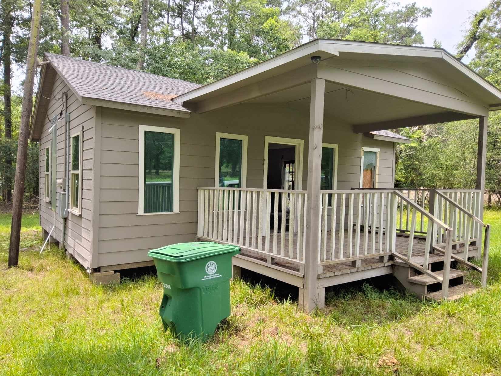 a view of a chair and table in backyard of the house